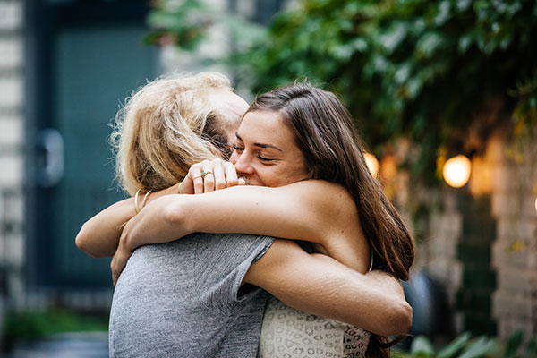 Photo of two white women hugging