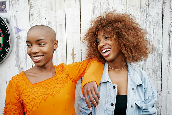 photo of two african american women laughing